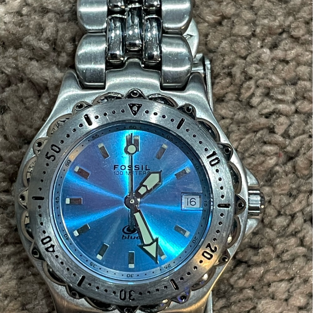 Fossil Blue women’s watch. Iridescent blue face with date.